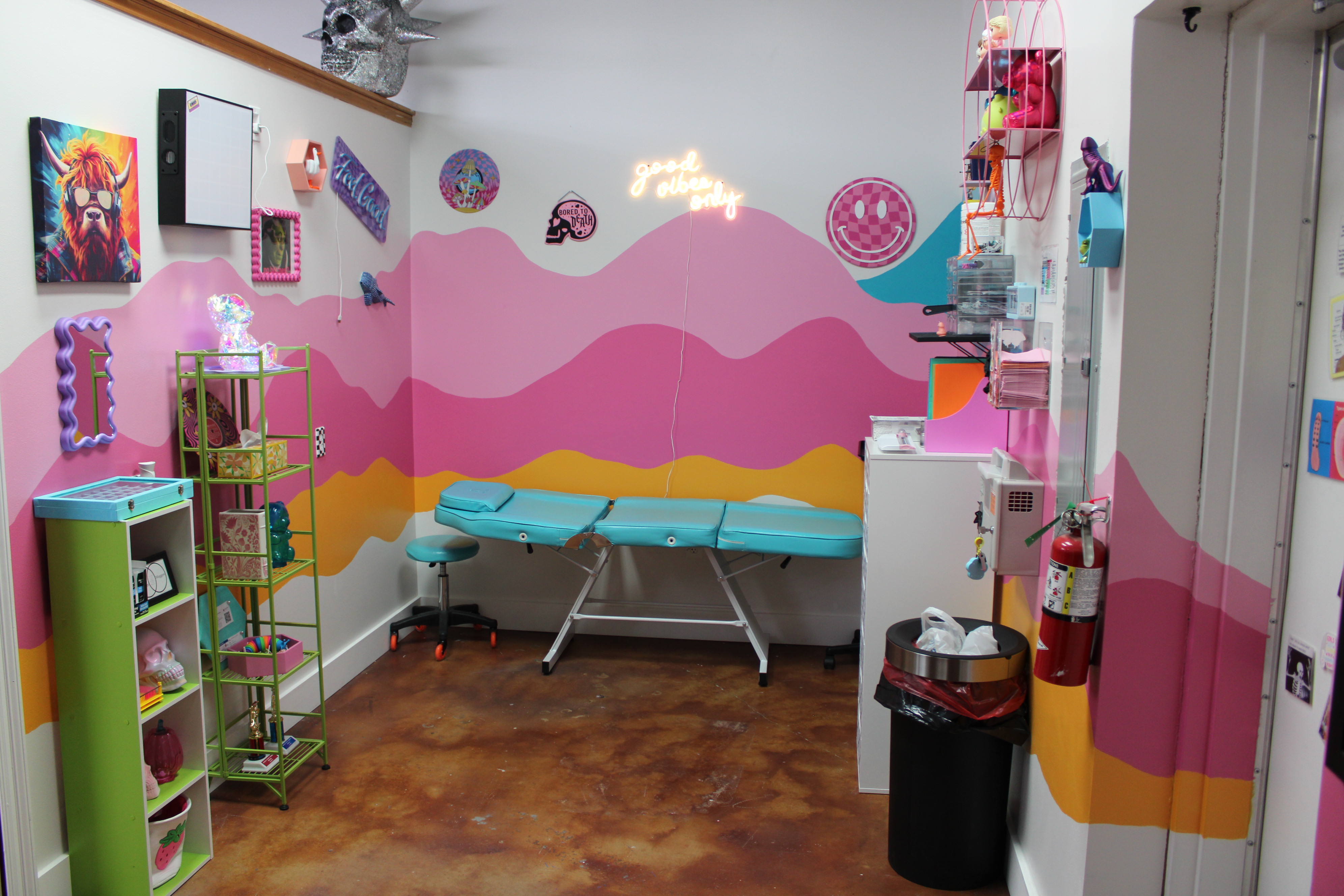Harley Halford's professional piercing studio in Houma, LA featuring turquoise piercing table, vibrant colorful murals, and sterile professional setup